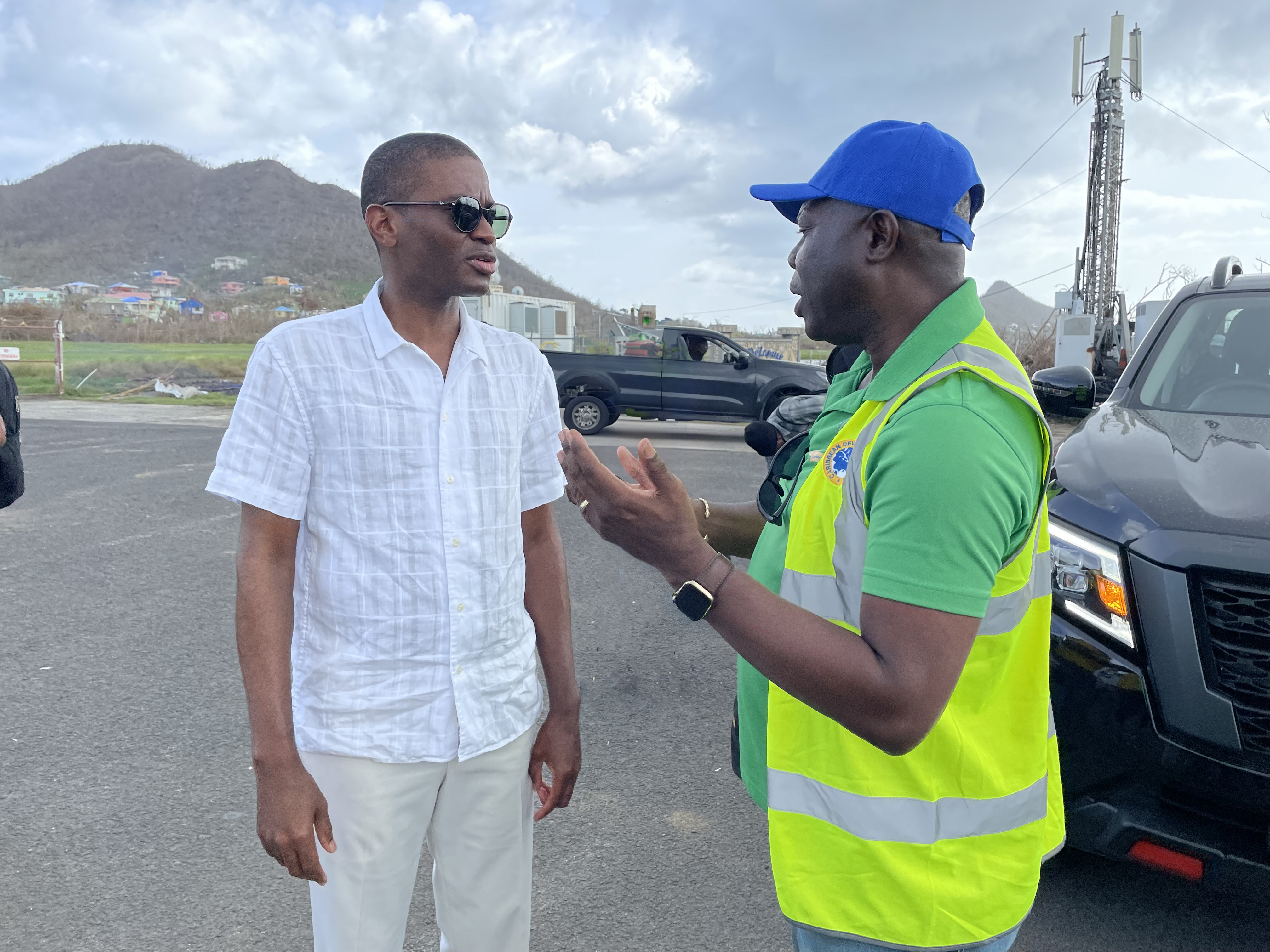 two gentlemen standing facing each other having a conversation