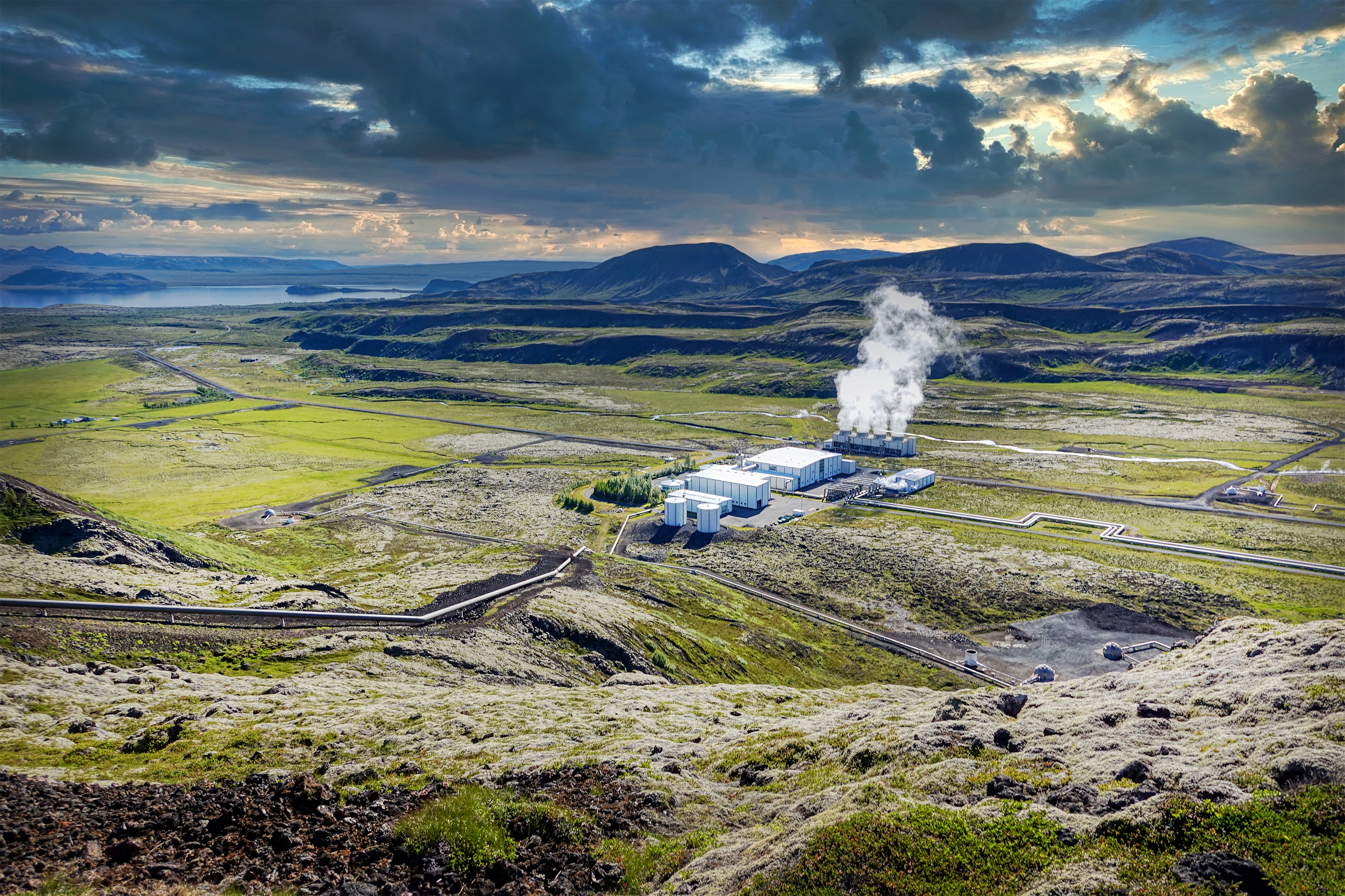 Geothermal energy plant in a vast green landscape