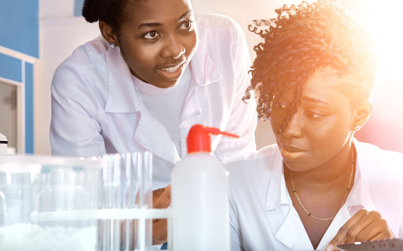 women in lab coats testing items