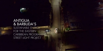 arial shot of street in Antigua and Barbuda with lone car on the road