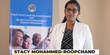 Stacy Mohammed-Roopchand standing in the white jacket with a black and white inside top