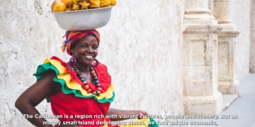 woman in traditional red dress with basket of fruits on her head