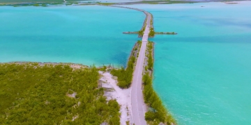 aerial shot of road connecting two land masses